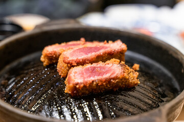 This Japanese-style fried beef steak, known as Gyukatsu, is a mouthwatering dish featuring a perfectly crispy, golden-brown crust with a tender, juicy interior. Cooked to perfection on a sizzling hot 