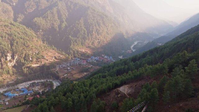 Morning fog enveloping Phakding, mountainside Nepalese village nestled in the Himalayan region serving as key acclimatization point for trekkers