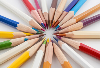 Fototapeta premium Close up colored pencils arranged in white background concept school