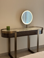 Modern vanity table with a marble top and round LED mirror