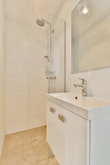 A sleek modern bathroom featuring a minimalist design with white tiles, a stylish sink, and a shower. Ideal for contemporary home aesthetics.