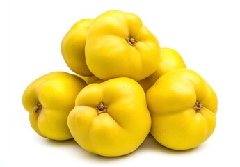 Close up of a pile of ripe, yellow quinces on a white background. The quinces are slightly textured and appear juicy