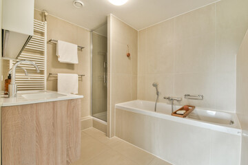 A sleek and contemporary bathroom featuring a bathtub, shower, and stylish fixtures, creating a serene and elegant atmosphere for relaxation.
