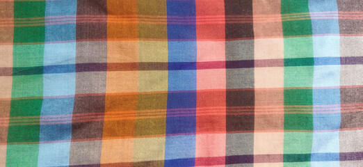 Bright and colorful checkered fabric pattern creating an eye-catching, artistic and stylish effect, suitable for backgrounds, designs, or fashion inspiration.