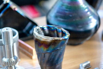 Objects printed with a 3D printer from a filament of molten metal on a table.