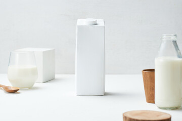 Milk Carton Positioned Centrally on a Minimalistic Table With Various Containers, Creating a Clean and Modern Kitchen Atmosphere