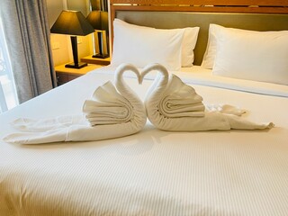 Hotel room with a bed decorated with swans