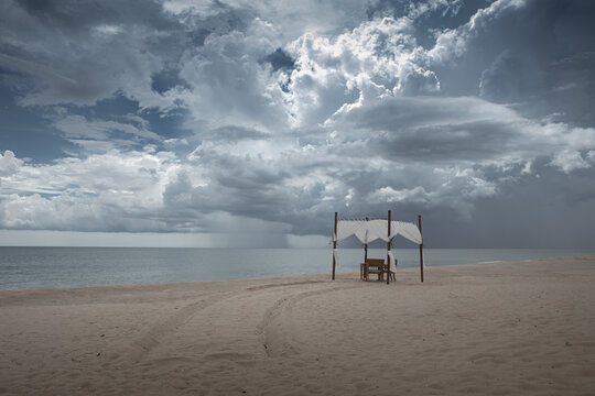 Panoramic view of  the cloudy beach and tent in the distance