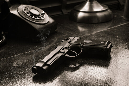 Close up black and white view of a gun in the detective office