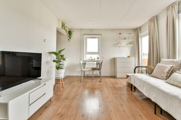 Bright and airy living room showcasing modern minimalistic design with light wooden flooring and...