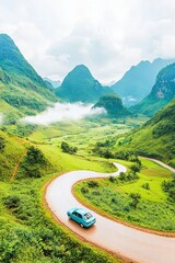 Fototapeta premium Vintage car on scenic winding road through lush green mountains on cloudy day