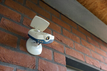 Outdoor surveillance camera above the entrance door to the premises