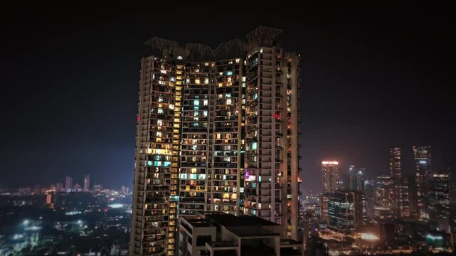 Aerial view of Mumbai city at night, showcasing the vibrant cityscape and skyline of Central Mumbai, including Lalbaug-Parel, Lower Parel, Worli, and Curry Road, with illuminated residential apartment