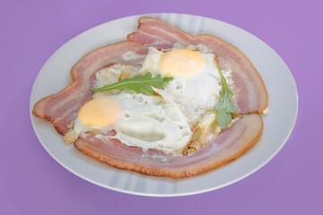 Fried eggs with bacon on a pink background close-up