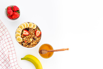 Breakfast with cereal granola honey and strawberry, top view