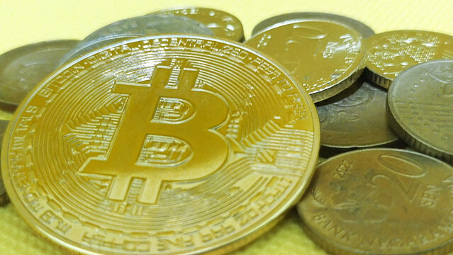 Gold Bitcoin Standing Out Against a Pile of Traditional Fiat Currency Symbolizing the Rise of Digital Finance - Powered by Adobe