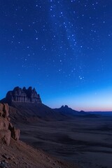 Obraz premium Majestic Desert Landscape Under a Starry Night Sky Capturing the Tranquil Beauty of Nature and the Vastness of the Universe with a Wide Angle