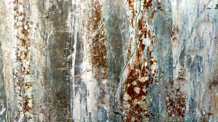 A close-up of a textured surface with weathered features and stains, showcasing natural patterns of aging and wear that contribute to the rugged aesthetic.