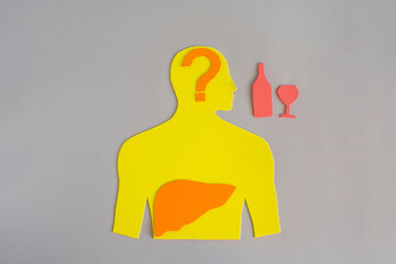 The silhouette of a man with a highlighted liver, alcoholic beverages and a question mark is...