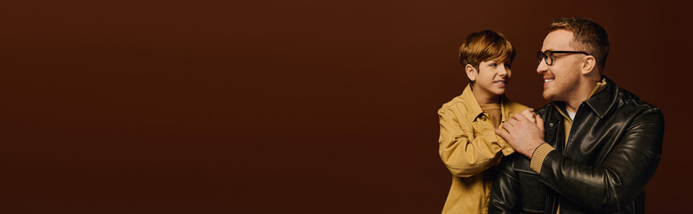 Happy father and son share joyful moments in a stylish studio setting together