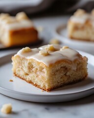 Delicious apple cake slice with creamy glaze and crumble topping on white plate food photography