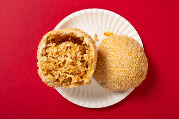 top view traditional Chinese fried sesame ball on red at horizontal composition