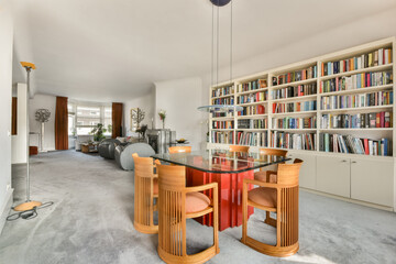 A contemporary living room featuring stylish furniture, a well-organized bookshelf, and a cozy atmosphere, ideal for relaxation and gatherings.