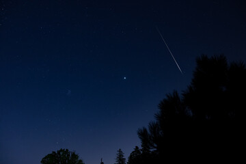 Fototapeta premium Perseid meteor shower, Milky way stars and landscape silhouettes
