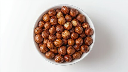 Obraz premium Hazelnuts in white bowl, studio shot, white background