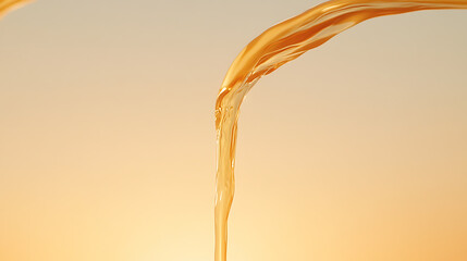 Golden Liquid Pour: A stream of amber fluid gracefully flowing against a soft, gradient backdrop. Captivating motion and subtle translucence. Refreshing!