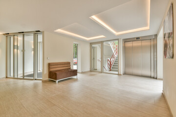 A sleek and modern interior lobby featuring stylish lighting, an elevator, and a minimalistic design. Perfect for contemporary architectural showcases.