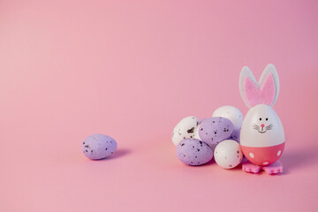 cute easter bunny and eggs on pink background. easter greeting card.pink easter eggs in the nest...