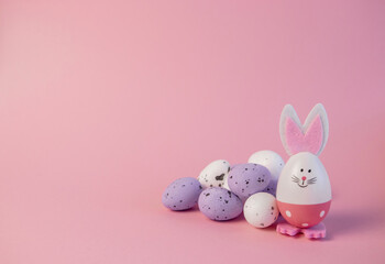 cute easter bunny and eggs on pink background. easter greeting card.pink easter eggs in the nest and easter bunny. 