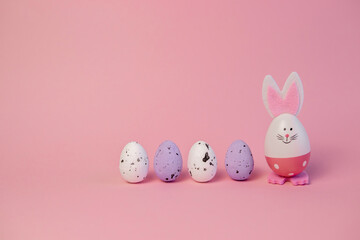 cute easter bunny and eggs on pink background. easter greeting card.pink easter eggs in the nest and easter bunny. 