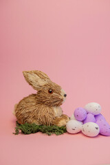 
Easter bunny with pink Easter eggs.  Easter card. Easter composition. rabbit and eggs on a pink background. Easter bunny, eggs, bunny and flowers.