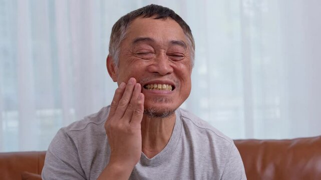 Asia old senior men suffering from severe toothache, holding him cheek and suffering strong dental pain on white background, tooth decay, tooth sensitivity, oral health care concept.