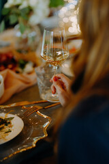 Elegant dining setting with a glass of white wine and gourmet dish