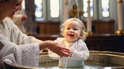 a child is baptized in water in a Christian church, a religious rite, a sacrament, Orthodoxy, Catholicism, a temple, a priest, baptism, christening, immersion, Epiphany