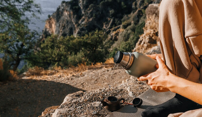 A serene and peaceful moment spent in the embrace of nature, accompanied by a thermos, ideal for all adventure lovers