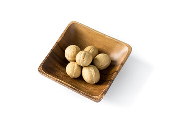 Walnut in the shell , in a wooden bowl. Common in the shell  walnut tree Juglans regia . A bowl of nuts on a white background , top view .