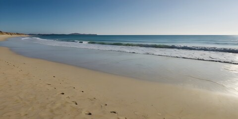 Obraz premium Lonely Coastline with Golden Sand and Blue Sky