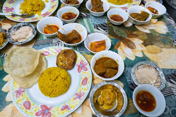 Traditional bengali food feast featuring luchi, pulao, and various dishes