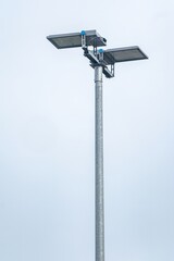 Led floodlights lighting up the sky on a metal pole