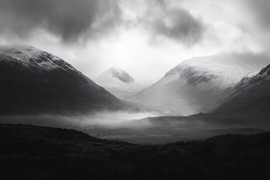 Dramatic Mountain Landscape: A dramatic black and white landscape showcases a rugged mountain range under a brooding, cloud-filled sky, creating a sense of vastness. 