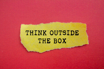 Think outside the box message written on ripped torn yellow paper on red background. Conceptual think outside the box symbol. Copy space.