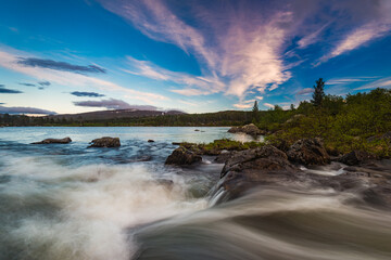 Breathtaking river landscape under a vibrant sky in the late afternoon