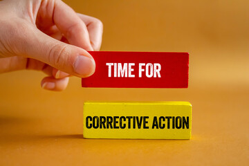 Time for corrective action message written on wooden blocks on brown background. Conceptual time...