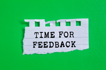 Time for feedback message written on ripped torn paper on green background. Conceptual time for...