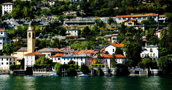 view of church and village along coast line of Lake Como Italy 