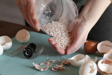 Preparing Eggshell Powder. Woman grinds eggshells with blender. Calcium supplement, cracked eggshell, natural compost ingredient, broken eggshell